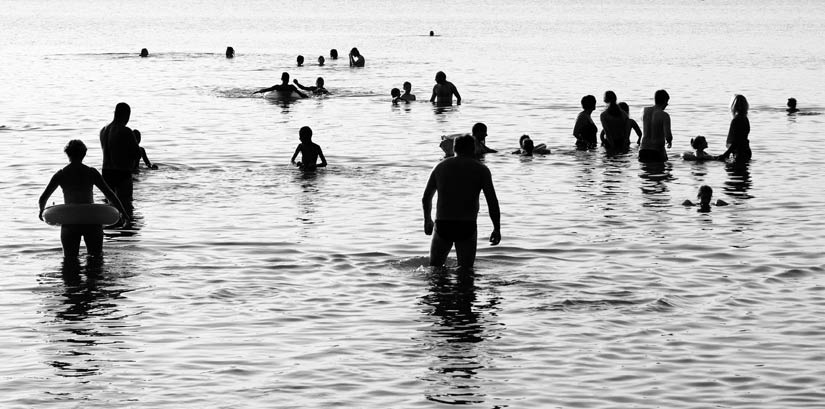 A group of people swimming at the beach