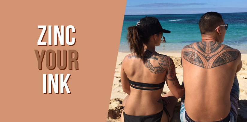 Two people at the beach with tattoos